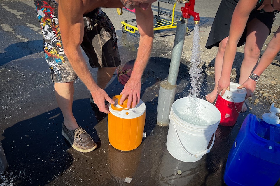 Running water at 鶹ѡ's Tent City helps pups and people stay hydrated and cool.