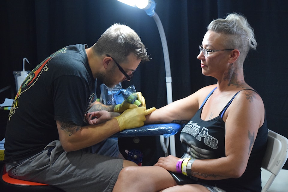 Kurtis Rogers tattooing a client at his first Okanagan Tattoo Show on July 21, 2024. 