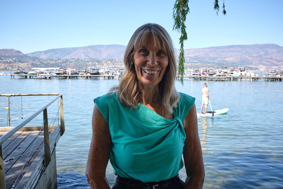 Canada's Elaine Tanner aka Mighty Mouse standing on the shores of Okanagan Lake in  