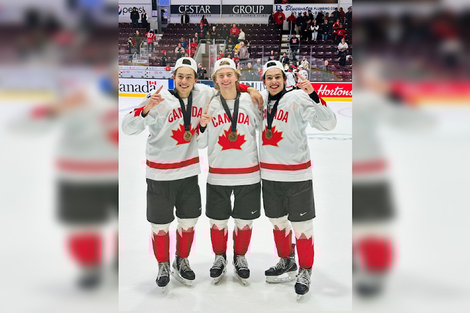 Mathis Preston, Liam Ruck, and Markus Ruck celebrate their gold and silver medal wins at the 2024 U17 World Challenge, which took place Nov. 1-9 in Sarnia, Ontario.
