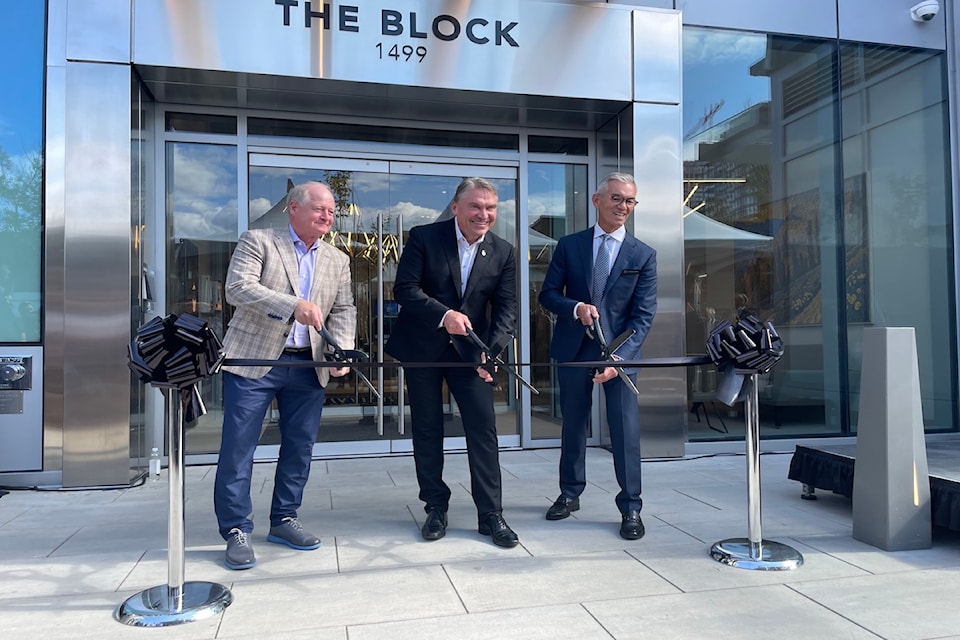Mission Group CEO Johnathan Friesen (right) cuts the ribbon on the company's The Block Office Tower alongside  Mayor Tom Dyas (centre) and Nicola Wealth Executive Managing Director Mark Hannah (left). 