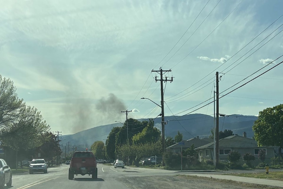 Smoke is visible in Kelowna from an RV on fire in an alley behind Woodlawn Street on April 30, 2025. 