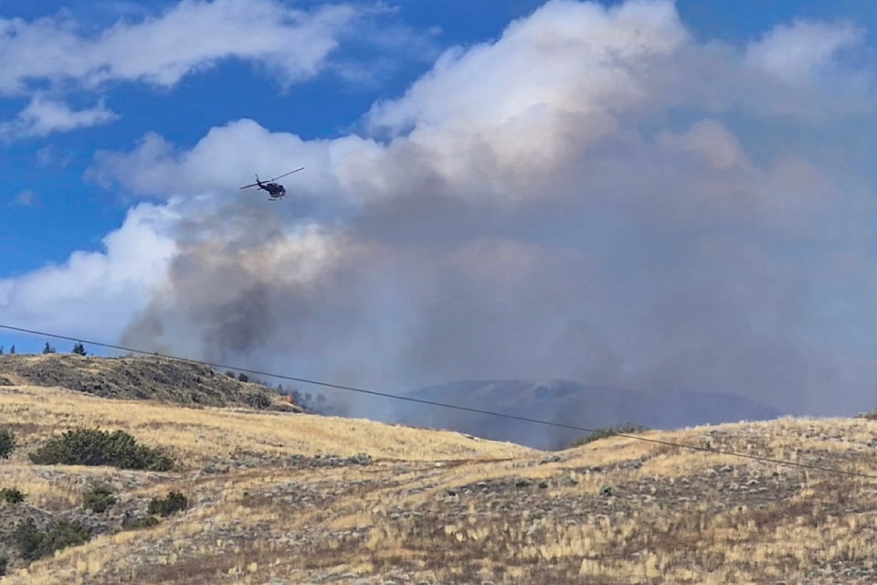 A helicopter is actioning a wildfire in Vernon on Aug. 17, 2025. 
