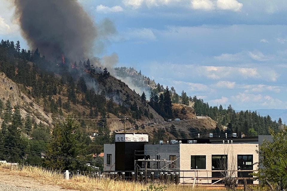 A wildfire burning off Highway 97 in Peachland on July 30, 2025. 