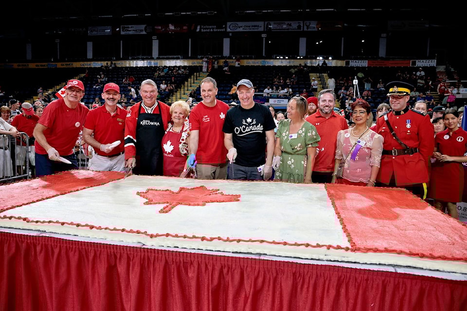 Okanagan MPs and MLAs, along with members of city council cut the Canada Day cake at the 50th Annnual Kelowna Folkfest on July 1, 2025.