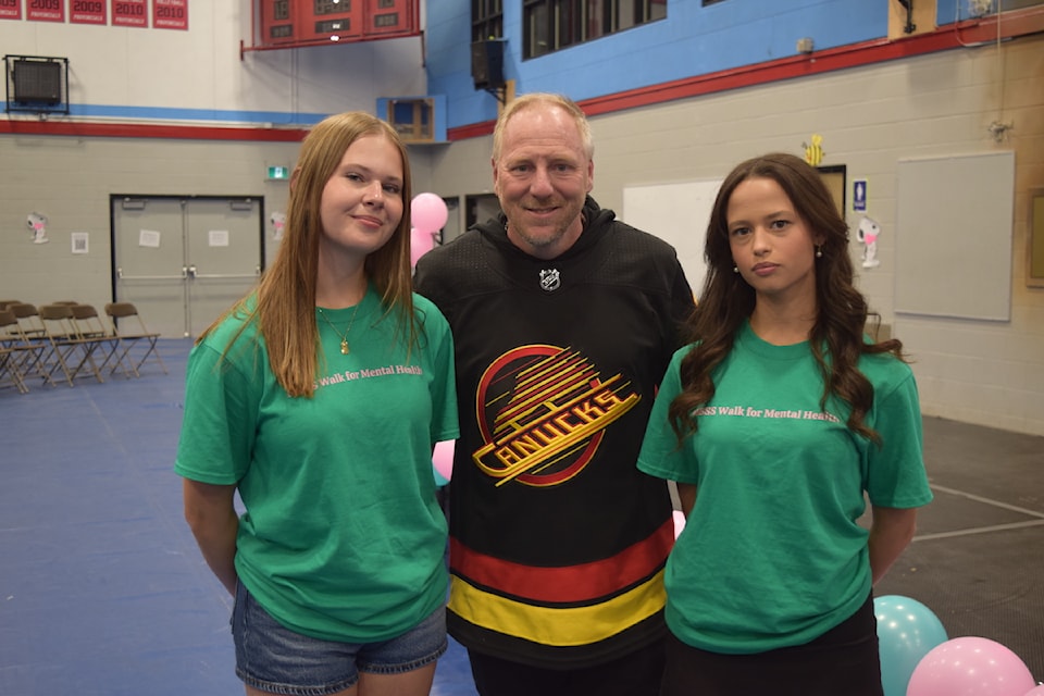 Students Delaney Neukomm (left) and Abigayle Hudson (right) stand with former NHL goalie Corey Hirsch between assemblies at Mount Boucherie Secondary School during the third annual Walk For Mental Health on May 8, 2025. 
