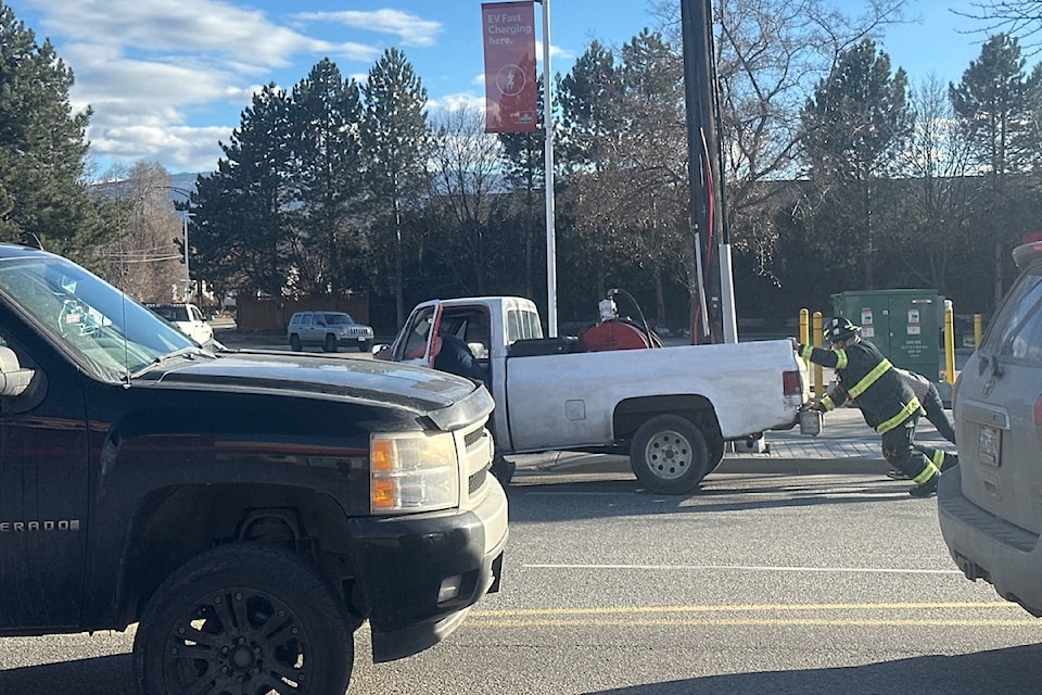Firefighters push truck off Leathead Road, March 3. 