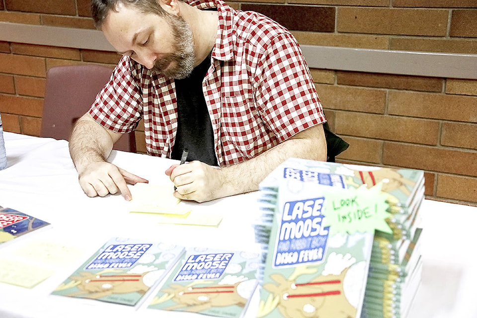 Douglas David Farrow Canadian cartoonist Doug Savage signs copies of Laser Moose and Rabbit boy during the Kelowna Comic and Collectibles Expo, Sunday, at Parkinson Recreation Centre.