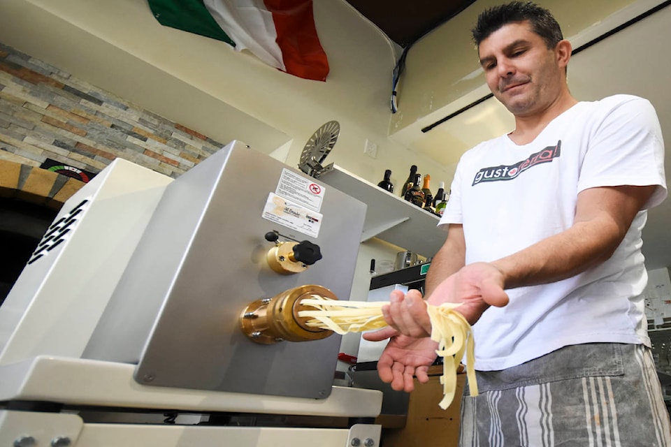 Flaminio Ferrari, owner of Gusto Ferrari Cuisine, handles the fresh pasta with care as it is churned out of the restaurant’s pasta maker. Ferrari explained they specially import Italian flour and pride themselves on offering high quality Italian cuisine to Penticton residents. (Mark Brett - Western News)