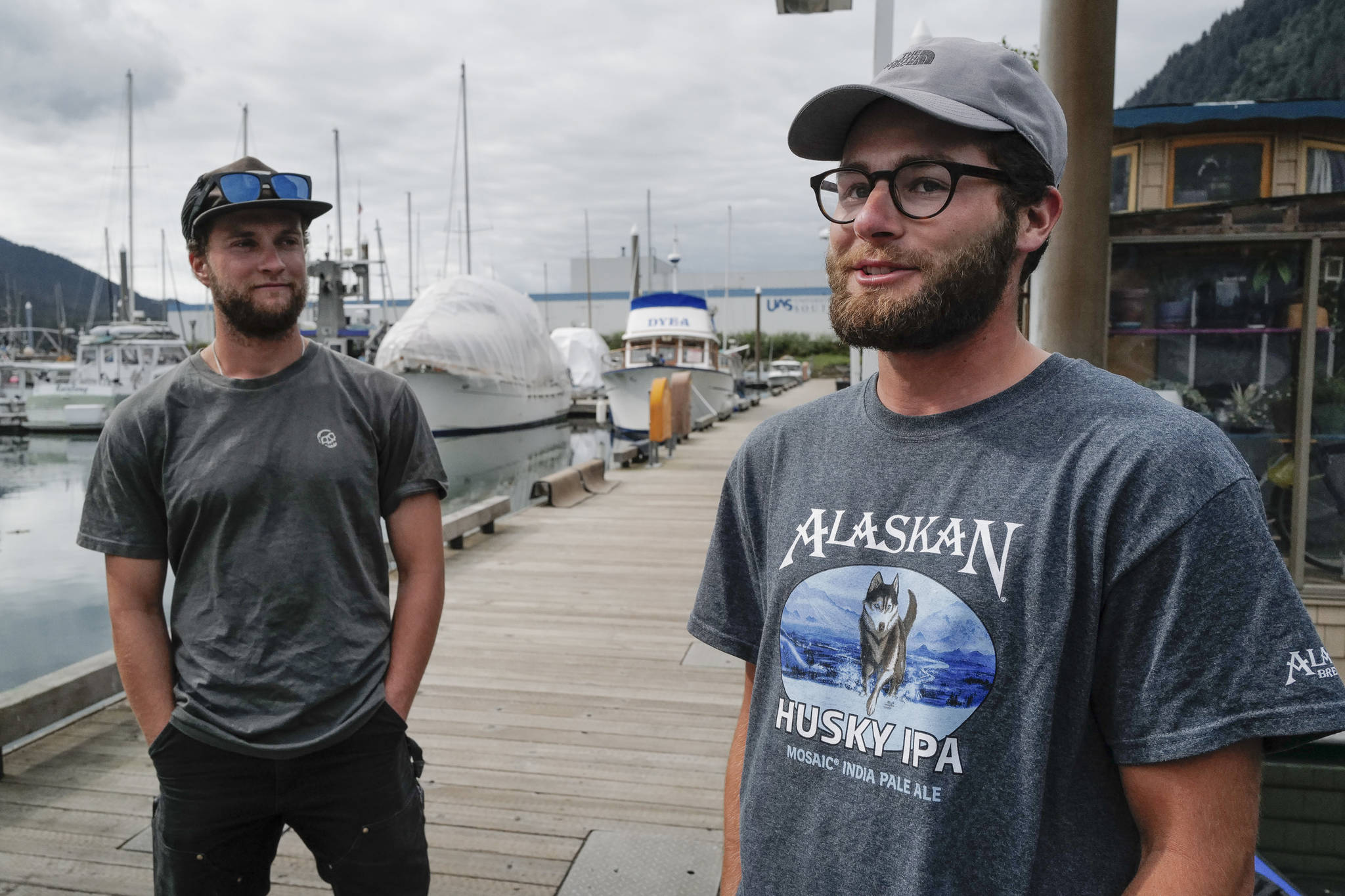 Liam Godfrey-Jolicoeur, left, and Jake Dombek, talk at Harris Harbor on Thursday, Aug. 2, 2019, about their nearly two-month long trip up the Inside Passage by canoe. Both are orginally from Vermont used the trip to raise money and bring awareness to environmental causes. (Michael Penn | Juneau Empire)