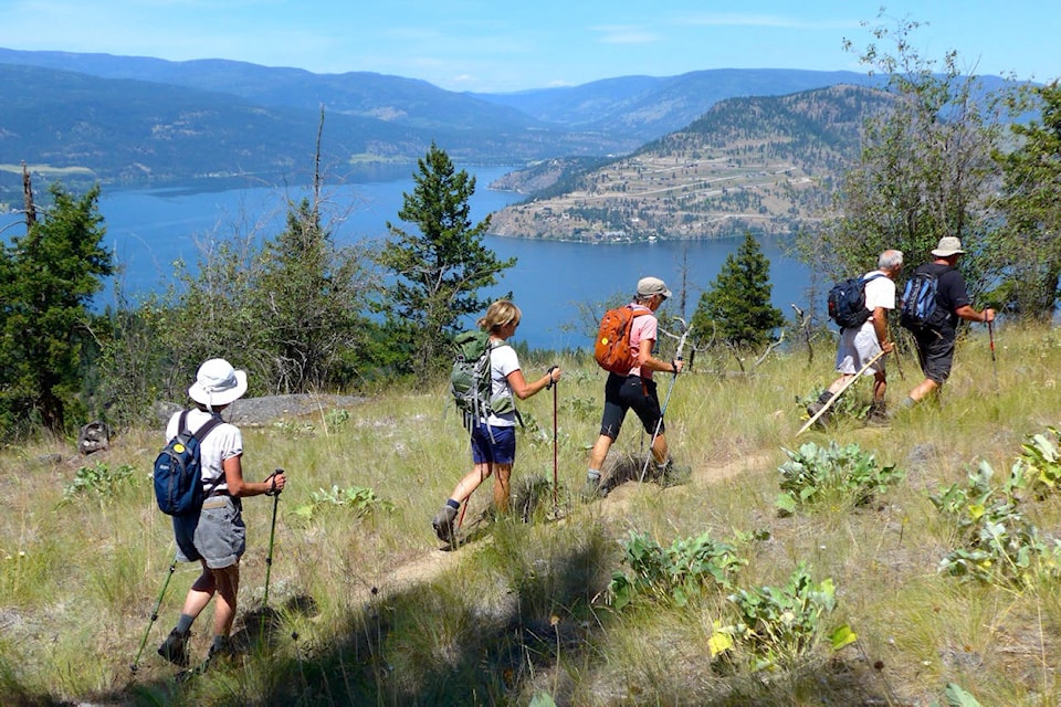 Hikers ramble near Sparkling Hill looking down on Adventure Bay on Okanagan Lake. (Colin Baxter /Black Press Media file photo)