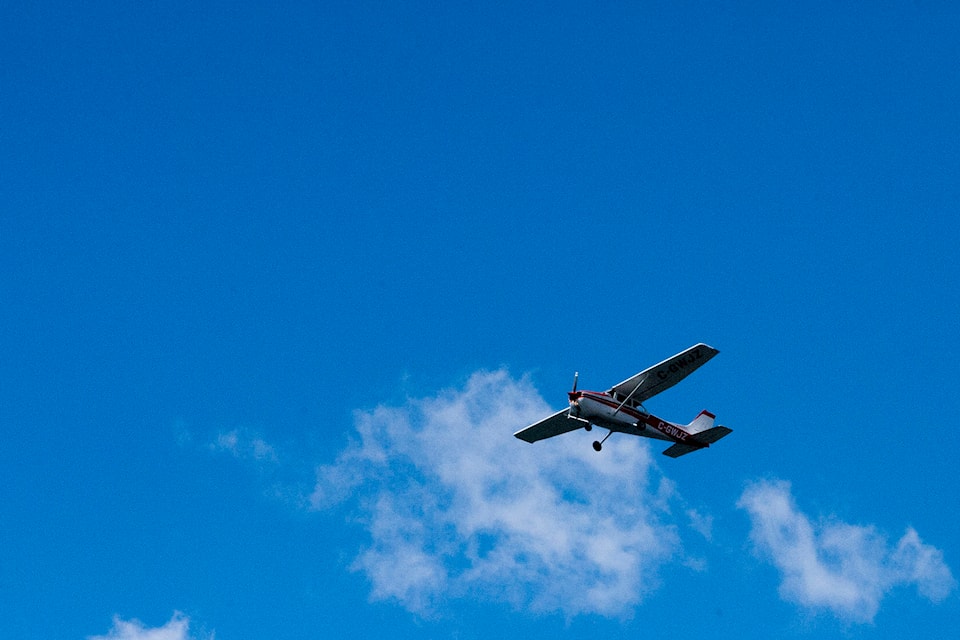 A plane flying over Okanagan Lake near downtown Kelowna on May 18, 2020. (Michael Rodriguez - Capital News)