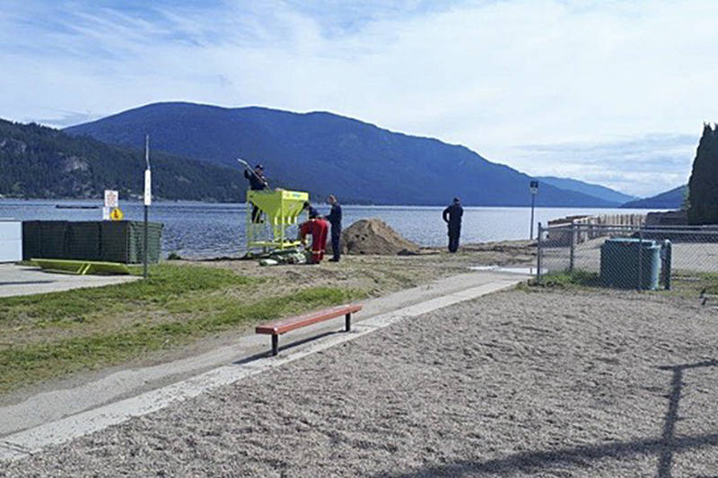 21715390_web1_200603-SAA-Canoe-Beach-filling-sandbags