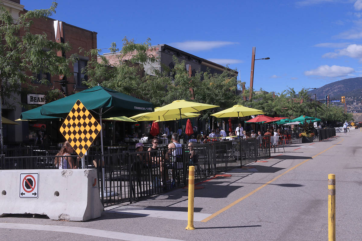 Brightly coloured patio umbrellas light up the lunch scene on Bernard Ave at Pondosy St, Tuesday, Sept. 1. (Laurie Tritschler - Black Press Media)