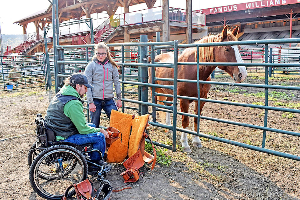 Thompson Rivers University Applied Sustainable Ranching Program students Kevin Cunin (left) and Wendy Meijdam show off a modified saddle recently made for Cunin, who is paralyzed from the chest down, so he can compete in team roping. (Rebecca Dyok photo)