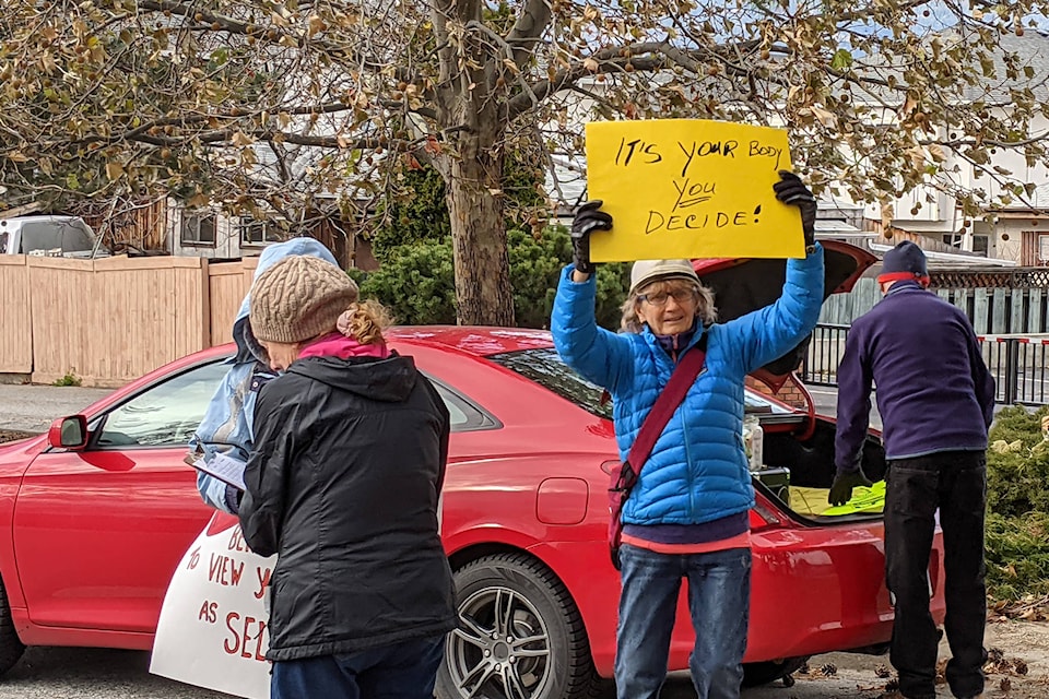 Multiple protesters cited unsubstantiated claims about the virus and the belief that their “rights are being violated” as reasons for their attendance. (Jesse Day - Western News)