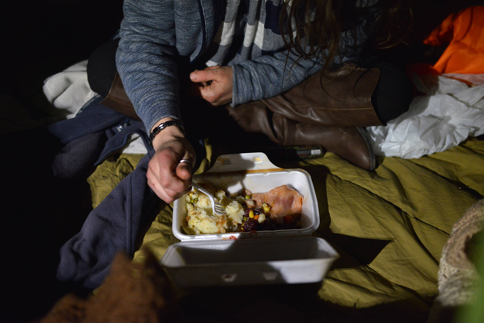 Stephanie Hermiston savours her turkey, stuffing, mashed potatoes, and gravy. (Phil McLachlan - Capital News)