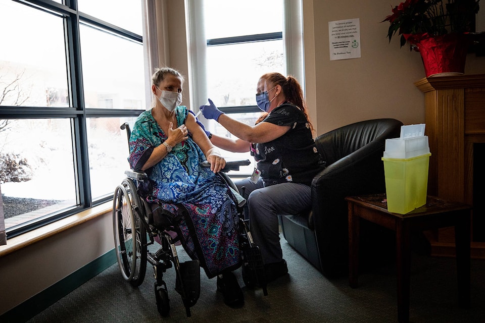 A mother and daughter in an Interior Health care home, who㽶Ƶֱs names are being withheld due to privacy, receive their COVID-19 vaccine together. (Photo courtesy of Interior Health)