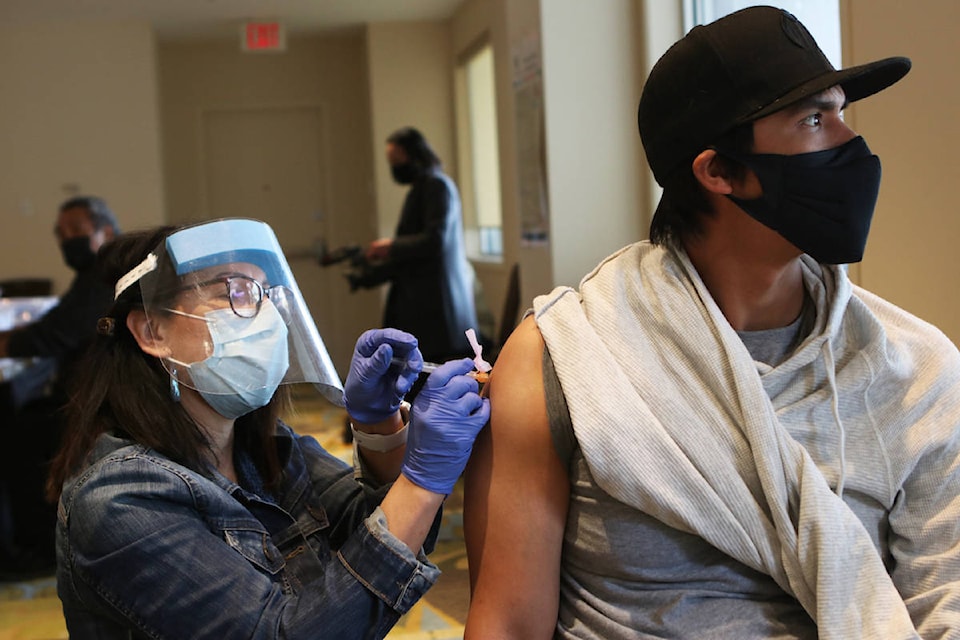 Danny Fulton receives his first dose of the COVID-19 vaccine at the Coast Capri Hotel on April 28. The pop-up clinic was hosted by the First Nations Health Authority. (Aaron Hemens/Capital News)