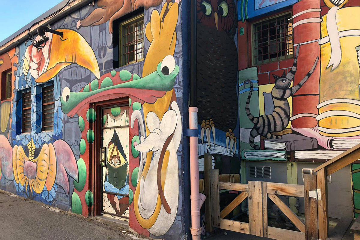 Tavis Stevenson, whose family owns The Book Shop, created the huge book mural along with his friend Darren. The large mural is in the back alley behind the Book Shop. (Monique Tamminga Western News)
