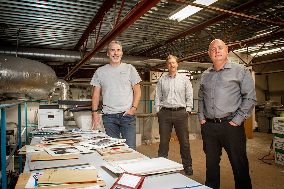 Skip Bartholomew’s sons, Stephen, current production manager (left) and Josh, current controller (C) with current Wayside owner Neil Perry. Overlooking tables of memories that have been collected and preserved over the past 100 years.