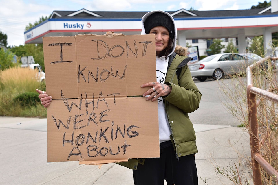 Chelsea Hobbs added a little humour to her poster during the vaccine card protests along the Trans-Canada Highway in Salmon Arm on Sept. 1. (Martha Wickett - Salmon Arm Observer)