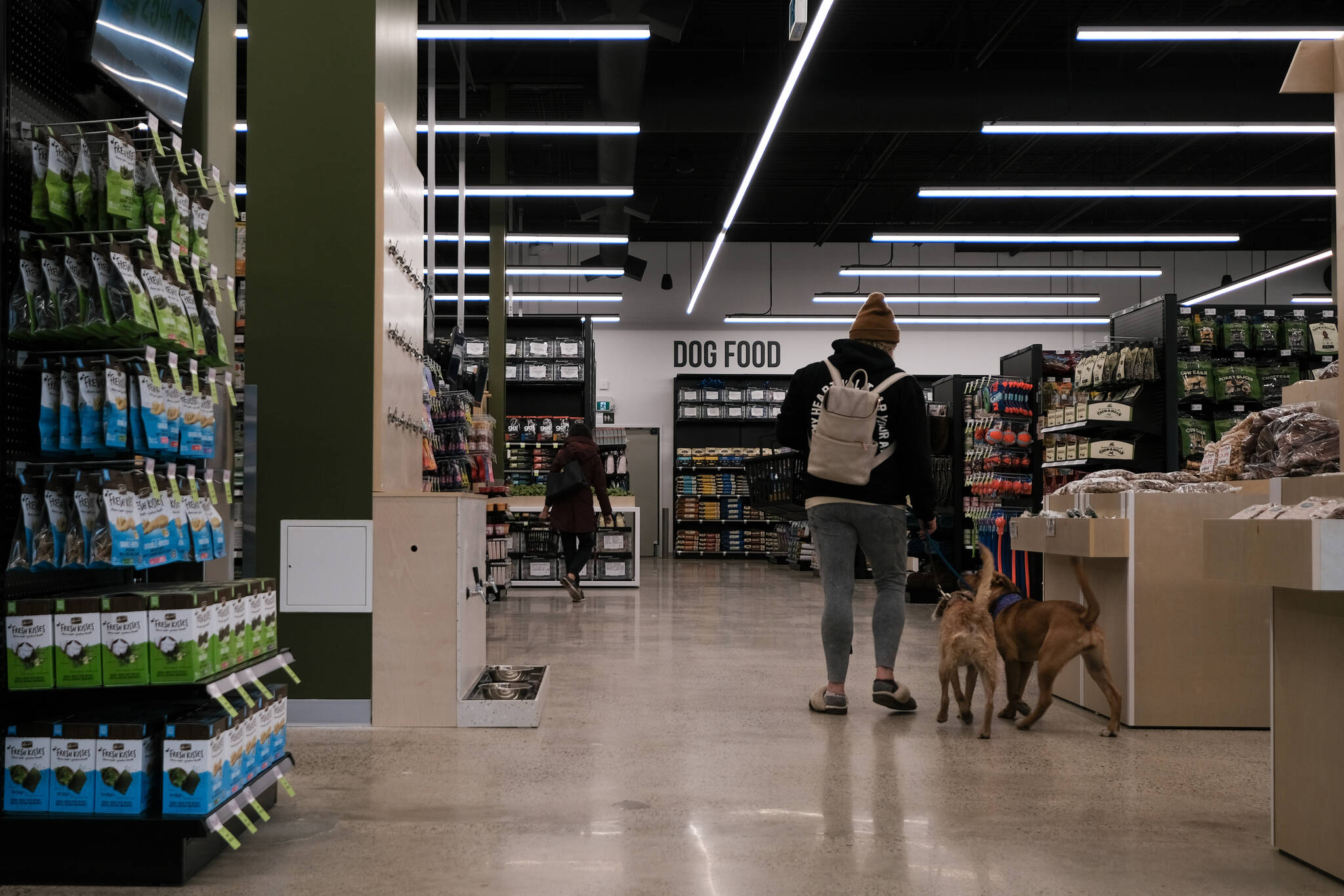 Two dogs and their owner checking out the new store (Jacqueline Gelineau/Capital News)