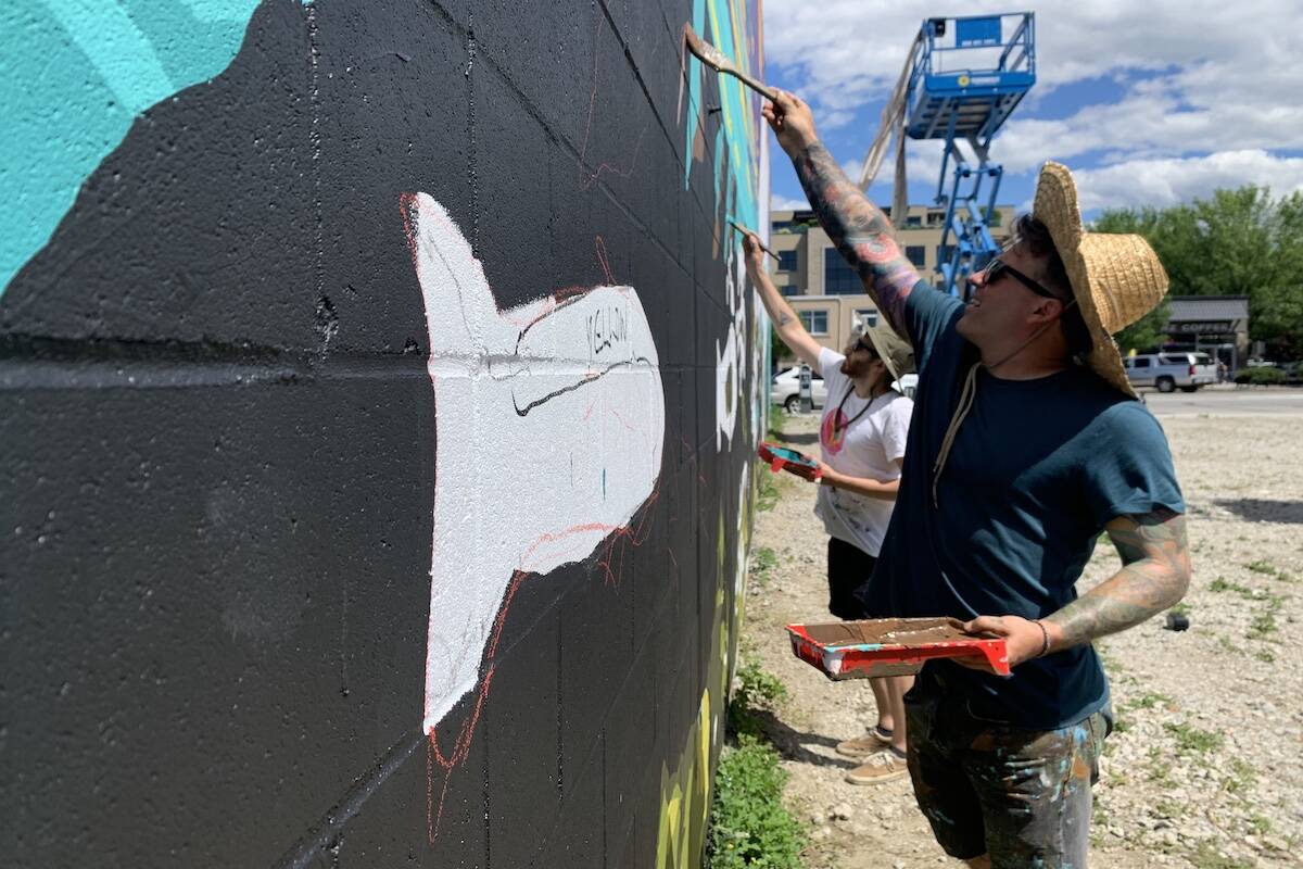 David Doody and his UBCO student paint a mural on Pandosy Street. (Jen Zielinski/ Black Press Media)