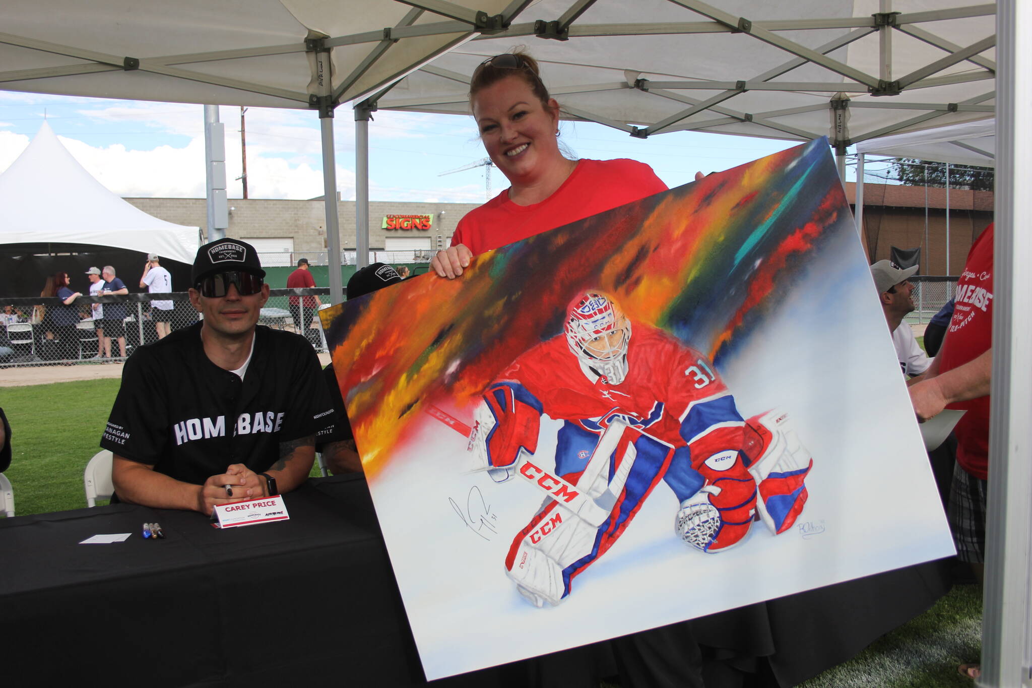 Brandy with her self-drawn Carey Price painting. (Jake Courtepatte/Capital News)
