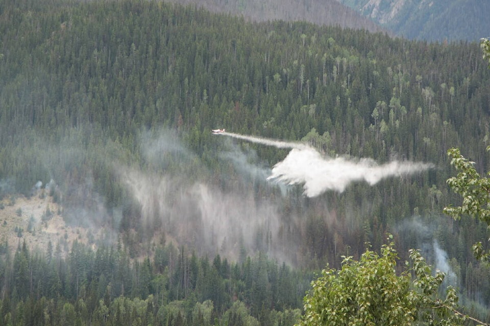 Parks Canada has received air support from the BC Wildfire Service in the battle against the fire. Their water skimmers were dropping water on the wildfire throughout the afternoon. The skimmers landed in Kinbasket Lake to fill their water tanks and proceeded to drop the tanks on the fire. (Contributed by Parks Canada)