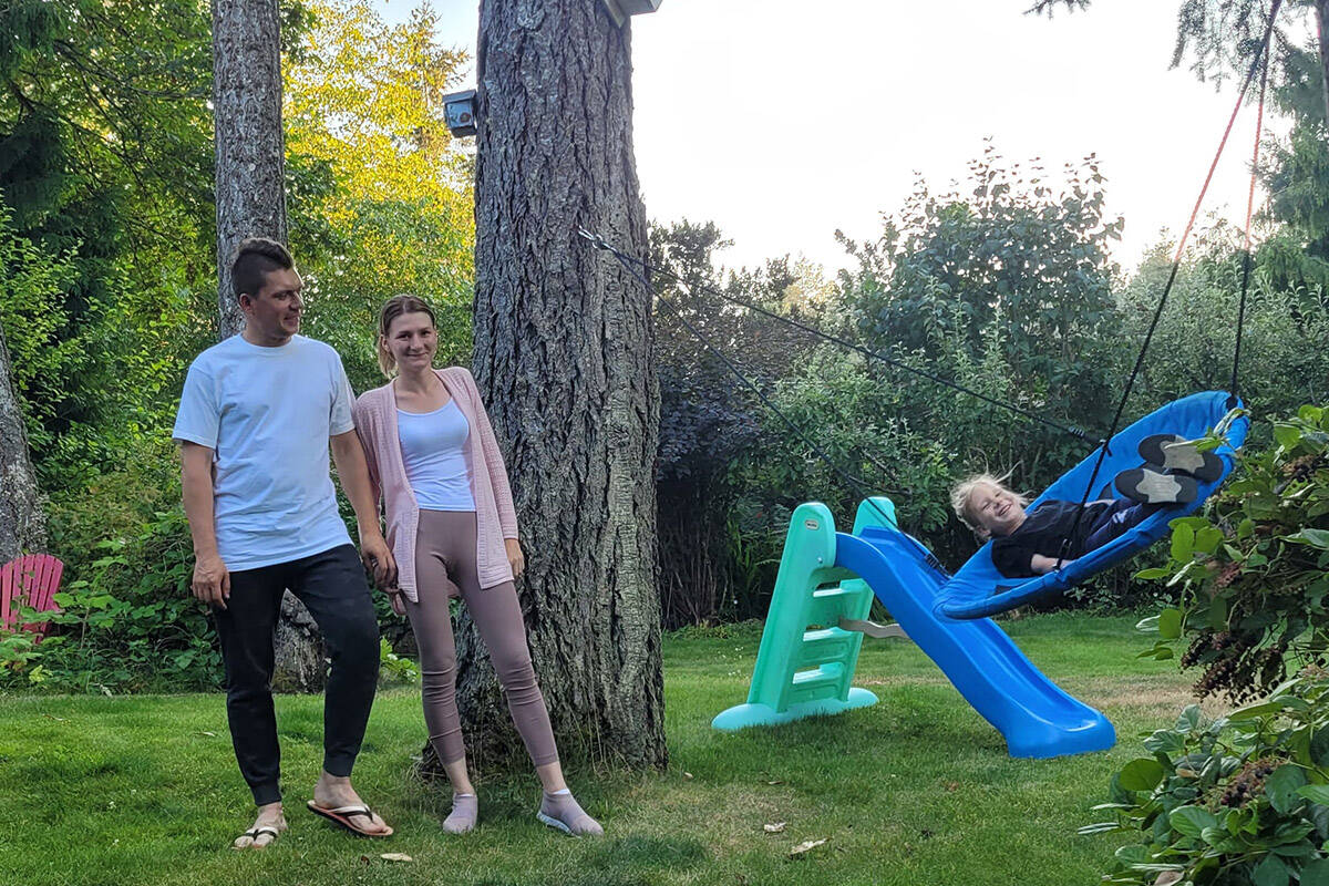 Valerii and Anastasiia Didenko are with their five-year-old daughter, Nikol, who is playing on a swing at the North Saanich couples home the family has been staying at since May 31. (Black Press Media)