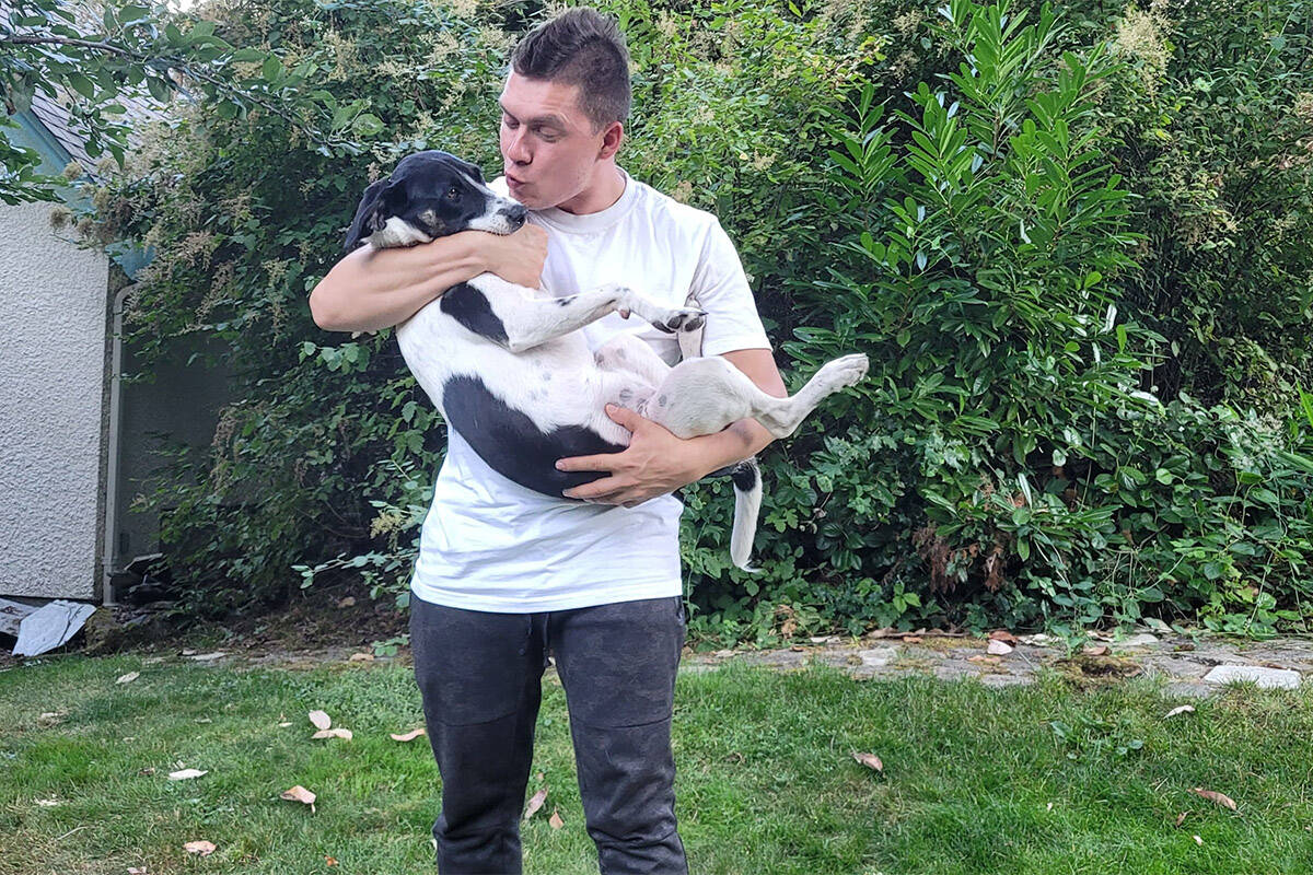 Valerii Didenko is seen with Paul Fussell and Cathy Jansens dog, named Lucy. (Black Press Media)