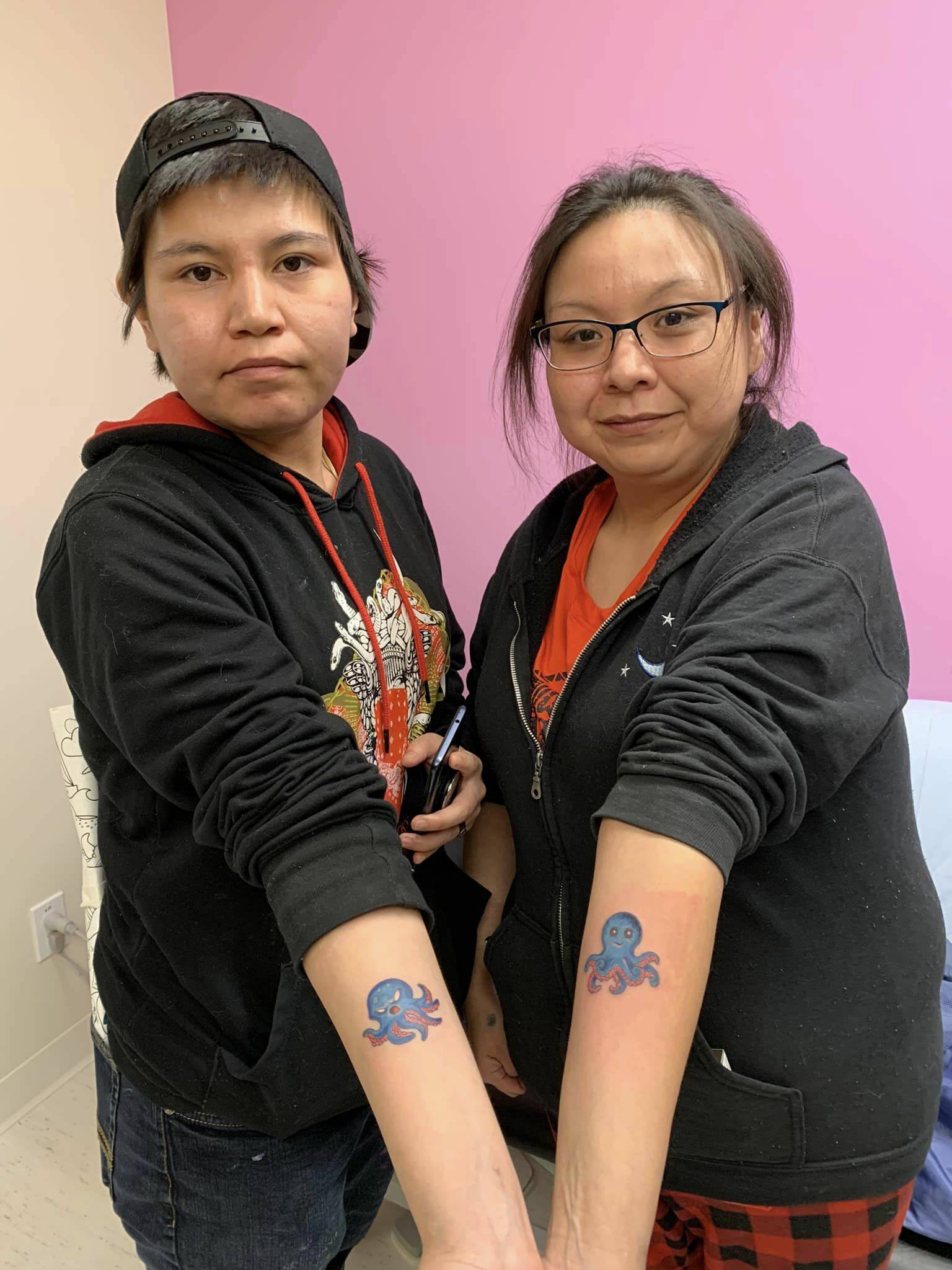 Two attendees show of their new ink at Paps and Tats on March 8. (Photo by Gerry Eyre)