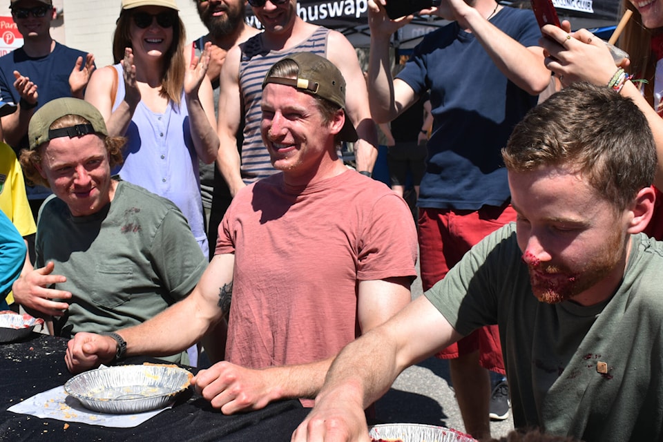Cooper Butchard (middle) is the winner of the 2023 Salty Street Festival pie-eating contest on Saturday, May 13, 2023. (Rebecca Willson-Salmon Arm Observer)
