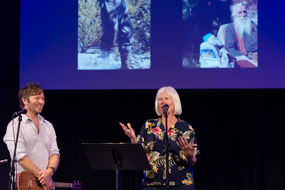 Grant Lawrence listens as Audrey Stremick of Malakwa shares her side of Lawrence’s story about how Russell Letawsky, aka Russell the Hermit, came to arrive in Desolation Sound, during the Grant Lawrence and Friends show at Song Sparrow Hall on Saturday, June 17, 2023. In 1977, Letawsky and Stremick hiked from Pemberton Meadows over the Coast Mountains from an area near Pemberton Meadows to the Malaspina Inlet where Stremick’s sister Linda lived. (Lachlan Labere-Salmon Arm Observer)