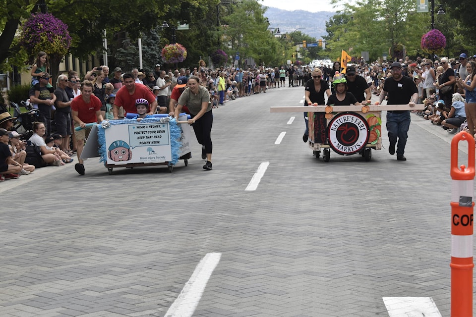 Jennifer Casey Memorial Peach Bin Race at Penticton Peach Festival on Aug. 9, 2023, featuring the teams representing the South Okanagan Similkameen Brain Injury Society and Nature’s Fare Markets. (Logan Lockhart/Western News)