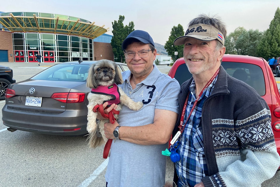 Fintry residents Real Gousy, Rick Walker and Elsa check in at the Emergency Support Services reception centre at Vernon’s Kal Tire Place Friday after being evacuated. (Jennifer Smith - Morning Star)