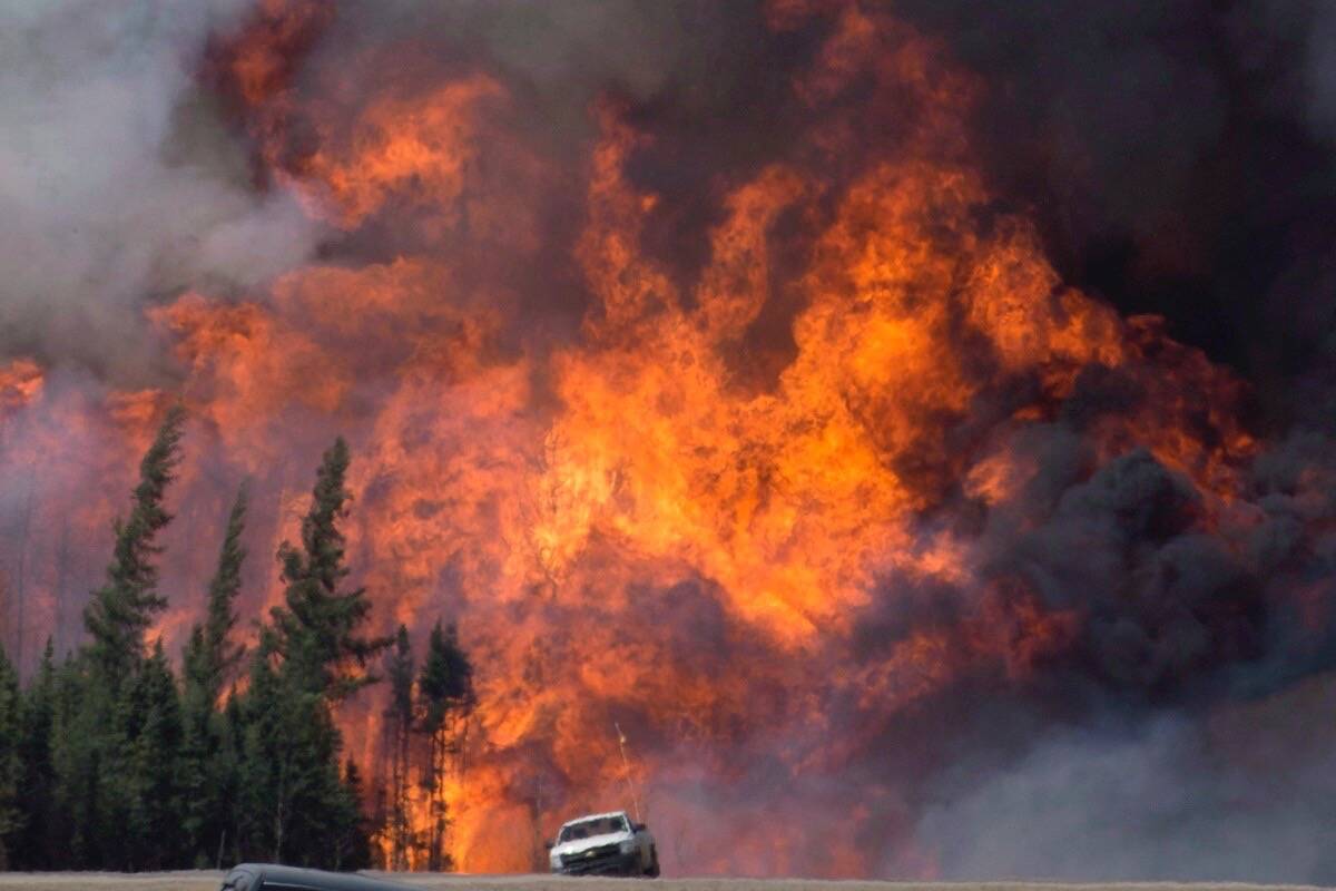 A giant fireball is seen as wildfire ripped through the forest south of Fort McMurray, Alta., on May 7, 2016. Photo: Jonathan Hayward/The Canadian Press