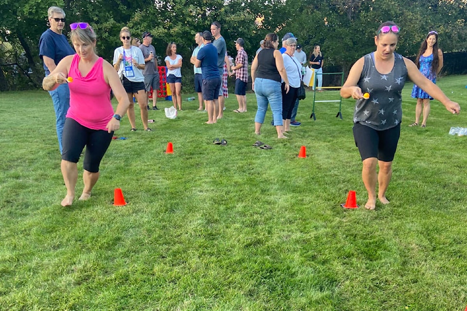 The ping pong ball relay was among the 40 yard games offered by the Vernon Winter Carnival Society Wednesday, Sept. 13, at its Grown Up Yard Games, Barbecue and Outdoor Movie Night at Mackie House in Coldstream. (Jennifer Smith - Morning Star)