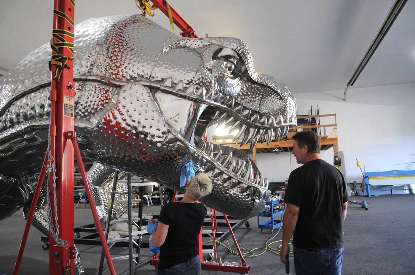 Kevin Stone and wife Michelle were putting the finishing touches on a 17,000-pound, stainless-steel T. rex on Thursday, Sept. 14, 2023, just days before it was to be shipped from Chilliwack to Penticton. (Jenna Hauck/ Chilliwack Progress)
