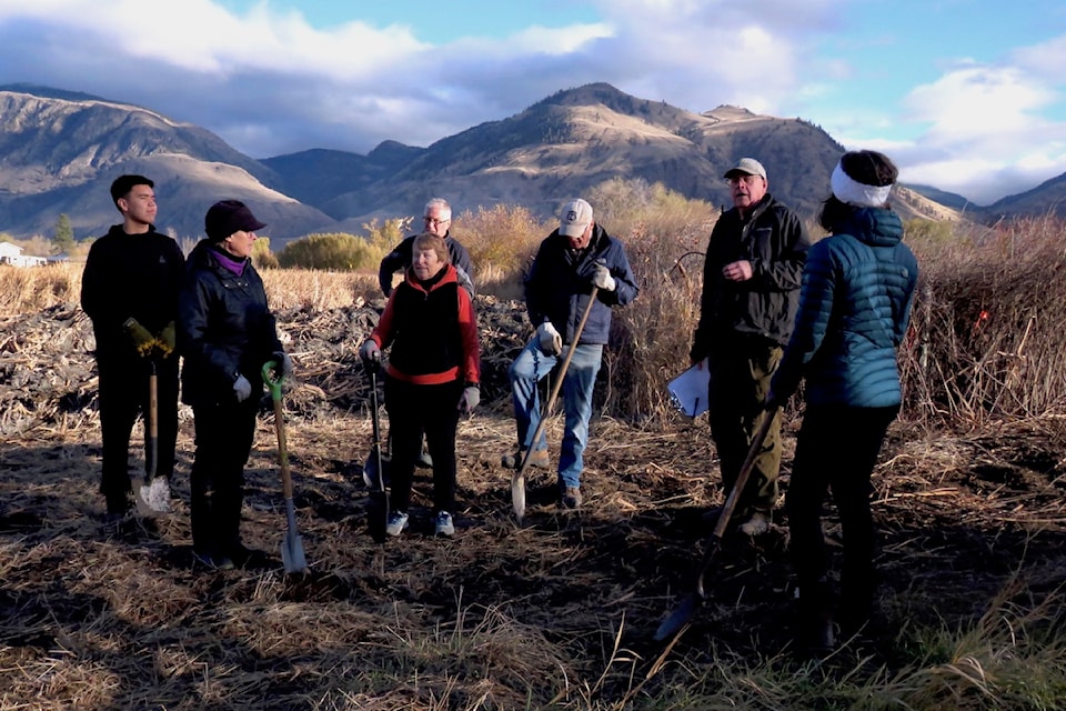             On the verge of Ginty’s Pond, an oxbow in the Cawston valley, early bird planting crew considers wetland restoration information from project manager, Al Peatt.                  