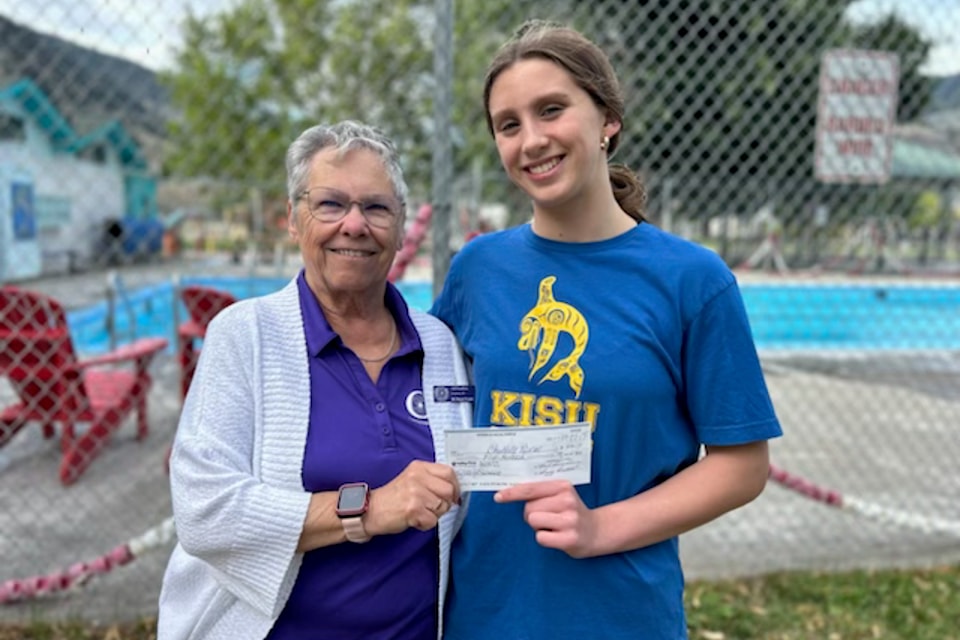 Gail Strandberg, president of the Keremeos Royal Purple, presents Marlee Winser with a bursary to offset costs for travelling to compete as an athlete. 