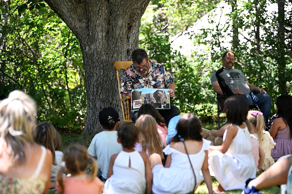 Christ Mathieson reads a story about all the bear - and bare - behinds at the zoo at the Teddy Bear Picnic at the Keremeos Grist Mill on July 12. 