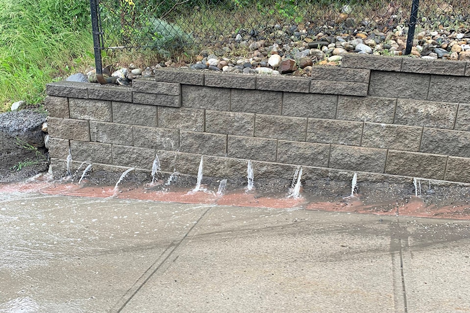 Water flows from behind the retaining wall along Hospital Hill on Highway 97 in Vernon Thursday, June 11, 2020. (Karen Hill - Black Press Media)