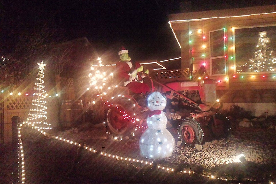 The famous stolen and returned Grinch sits proudly atop his tractor at 123 Granby Ave.