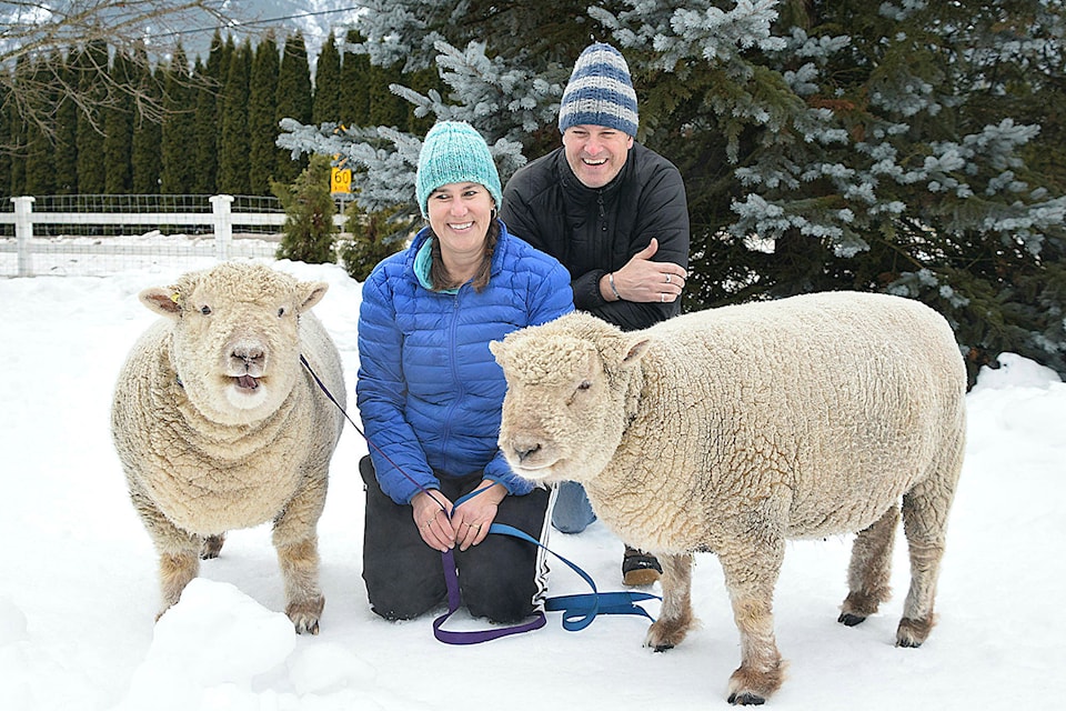Gin voices his view of having his photo taken as Ken and Karleen Kantymir pose with him and his brother Tonic. (Martha Wickett - Salmon Arm Observer)