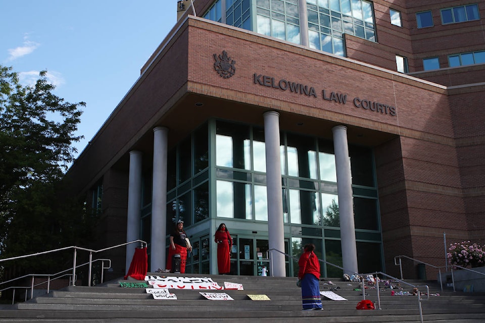Three women — Meagan Louis, Carol Laboucan and one who asked to remain anonymous — stood at the top of the Kelowna Law Courts’ steps on June 10, condemning Curtis Sagmoen and violence against women. (Aaron Hemens/Capital News)