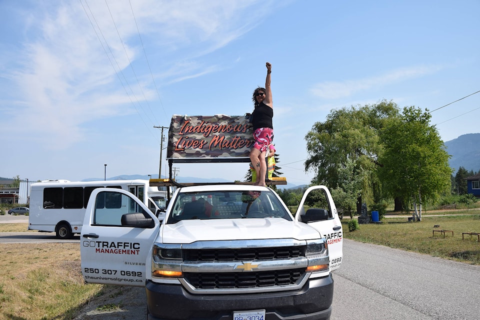 Organizer Jody Leon raises her fist ahead of the rollout of a slow-moving caravan from the Splatsin Community Centre to the former site of the Kamloops Indian Residential School on July 1, 2021. (Caitlin Clow - Vernon Morning Star)