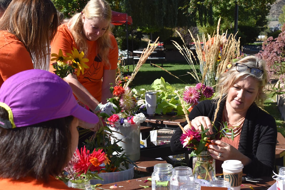 Volunteers are creating bouquets of freshly cut flowers from LocoLanding gardens on Tuesday. The 150 bouquets were delivered to students and staff Out’ma School on Penticton Indian Band land. (Monique Tamminga Western News)