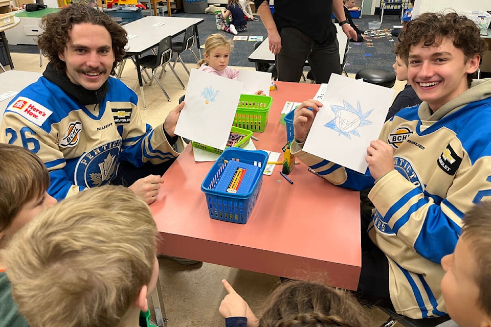 Josh Niedermayer and Cal Arnott from the Penticton Vees colouring the team’s logo at school on Tuesday, Nov. 15. (Photo- Penticton Vees/Twitter)